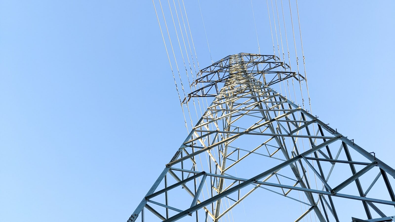 a tall metal tower with lots of wires on top of it